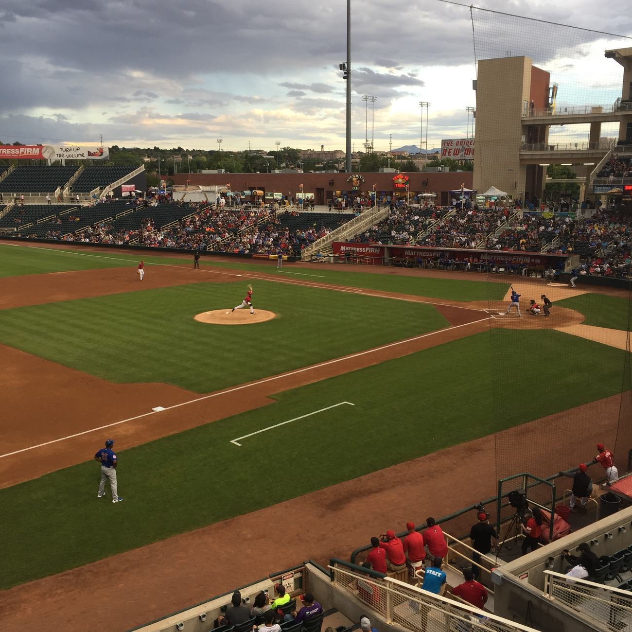 Isotopes Park in Albuquerque, monsoon clouds behind the grandstand